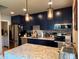 Modern kitchen featuring stainless steel appliances, a granite countertop island, and stylish lighting fixtures at 1778 S Lee St, Lakewood, CO 80232