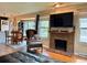 Cozy living room featuring a leather couch, fireplace, and open concept dining area at 1778 S Lee St, Lakewood, CO 80232