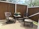 Cozy patio featuring comfortable chairs and a small table with decorative flowers at 1778 S Lee St, Lakewood, CO 80232