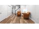 Finished basement sitting area with wood floors, arm chairs, and a stairway at 5951 E Irish Pl, Centennial, CO 80112