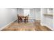 Finished basement dining area with wood floors, rug, and a bright window at 5951 E Irish Pl, Centennial, CO 80112