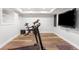 Finished basement gym area with wood floors, gym equipment, and a TV at 5951 E Irish Pl, Centennial, CO 80112