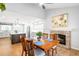 Open-concept kitchen and dining area with fireplace, hardwood floors, and stainless steel appliances at 5951 E Irish Pl, Centennial, CO 80112
