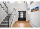 Bright foyer with hardwood floors, staircase, and a modern front door at 5951 E Irish Pl, Centennial, CO 80112