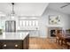 Open-concept living space boasts hardwood floors, modern lighting, and a cozy fireplace with a brick surround at 5951 E Irish Pl, Centennial, CO 80112