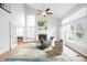 Bright living room featuring a fireplace, large windows, and high ceilings at 5951 E Irish Pl, Centennial, CO 80112