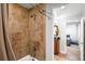 Close-up of shower featuring tile surround and updated fixtures at 5951 E Irish Pl, Centennial, CO 80112