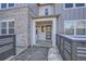 Townhouse entry with gray door and modern fence at 2555 W 69Th Pl, Denver, CO 80030