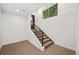 Basement stairs leading up to a door and window with a view of the backyard at 5372 W 68Th Ave, Arvada, CO 80003