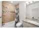 Bathroom features a shower and bathtub combo with granite vanity at 5372 W 68Th Ave, Arvada, CO 80003