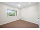 Well-lit bedroom with neutral carpet, and a large window bringing in natural light at 5372 W 68Th Ave, Arvada, CO 80003