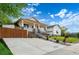 Wide concrete driveway leading up to a charming home with a welcoming front porch at 5372 W 68Th Ave, Arvada, CO 80003
