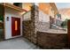 Charming home featuring a vibrant red front door and stone accents on the welcoming front porch at 5372 W 68Th Ave, Arvada, CO 80003