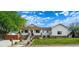 Charming home featuring a covered porch, manicured lawn, and stone accents at 5372 W 68Th Ave, Arvada, CO 80003