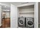 Modern laundry room with stainless steel washer and dryer and ample storage space at 5372 W 68Th Ave, Arvada, CO 80003