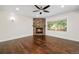 Cozy living room with a stone fireplace and hardwood flooring at 5372 W 68Th Ave, Arvada, CO 80003