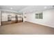 Spacious living room with kitchen area featuring stainless steel appliances and an open layout, great for entertaining at 5372 W 68Th Ave, Arvada, CO 80003