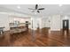 Open-concept living room featuring hardwood floors and a kitchen island with stone accents at 5372 W 68Th Ave, Arvada, CO 80003