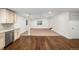 Spacious living room with updated kitchen including stainless steel appliances and hardwood floors at 5372 W 68Th Ave, Arvada, CO 80003