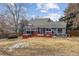 Inviting backyard featuring a red hot tub, a spacious deck, and a lush lawn at 8836 E Phillips Pl, Centennial, CO 80112