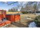 Well-maintained backyard with a red hot tub, a wooden deck, and a newly fenced perimeter at 8836 E Phillips Pl, Centennial, CO 80112