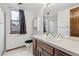 Bright bathroom with white countertop, wood cabinets, and a shower/tub combo at 8836 E Phillips Pl, Centennial, CO 80112