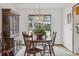 Classic dining room with large window, wood furniture, and bright natural light at 8836 E Phillips Pl, Centennial, CO 80112