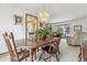 Traditional dining room with wood table, chairs, and a decorative chandelier fixture at 8836 E Phillips Pl, Centennial, CO 80112