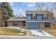 Charming two-story home featuring a mix of blue siding and brick with an attached two car garage at 8836 E Phillips Pl, Centennial, CO 80112