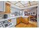 Cozy kitchen featuring wooden cabinets and hardwood floors adjacent to dining area at 8836 E Phillips Pl, Centennial, CO 80112