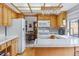 Well-lit kitchen with wooden cabinets and a partial view into a dining area at 8836 E Phillips Pl, Centennial, CO 80112