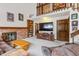 Open-concept living room featuring a brick fireplace and built-in shelving at 8836 E Phillips Pl, Centennial, CO 80112