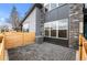 Modern home exterior with patio, gray pavers, gray siding, and stone accents at 9468 W 58Th Ln # C, Arvada, CO 80002