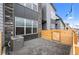 Modern home exterior with patio, gray pavers, gray siding, and stone accents at 9468 W 58Th Ln # C, Arvada, CO 80002