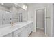 Elegant bathroom with double sink vanity, white cabinets, and glass-enclosed shower at 9468 W 58Th Ln # C, Arvada, CO 80002