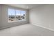 Bright bedroom featuring a large window and neutral-colored carpet at 9468 W 58Th Ln # C, Arvada, CO 80002