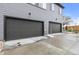 View of two garages and driveways on a gray home at 9468 W 58Th Ln # C, Arvada, CO 80002