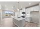 Stylish kitchen has white cabinets, quartz countertops, modern appliances, and an island perfect for entertaining at 9468 W 58Th Ln # C, Arvada, CO 80002