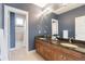 Well-lit bathroom with dual sinks, granite countertop, and walk-in shower at 3858 W 117Th Ct, Westminster, CO 80031