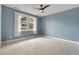 Inviting bedroom with blue walls, natural light, and plush carpet, creating a peaceful and relaxing environment at 3858 W 117Th Ct, Westminster, CO 80031