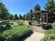 Community park featuring playground, covered seating area, and lush green space for recreation at 3858 W 117Th Ct, Westminster, CO 80031