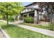 Inviting home showcasing a covered porch, stone pillars, and lush green lawn and landscaping at 3858 W 117Th Ct, Westminster, CO 80031