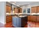 Spacious kitchen features wooden cabinets, stainless steel appliances, and a dark island at 3858 W 117Th Ct, Westminster, CO 80031
