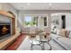 Bright living room with a modern fireplace, hardwood floors, and large windows at 3858 W 117Th Ct, Westminster, CO 80031