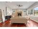 Bright living room featuring a modern fireplace, ceiling fan, and hardwood floors at 3858 W 117Th Ct, Westminster, CO 80031