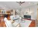 Open-concept living room with a view of the kitchen, hardwood floors, and natural light at 3858 W 117Th Ct, Westminster, CO 80031