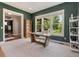 Well-lit office with a wooden desk, shelving, and a view of the beautifully landscaped yard at 3858 W 117Th Ct, Westminster, CO 80031