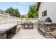 Outdoor patio with built-in grill, counter, and dining area with cushioned seating at 3858 W 117Th Ct, Westminster, CO 80031