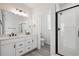 Modern bathroom features double sinks, a glass shower, and sleek fixtures at 1269 Penner Dr, Erie, CO 80026