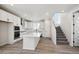 Bright kitchen featuring white cabinets, center island, and stainless steel appliances at 1269 Penner Dr, Erie, CO 80026